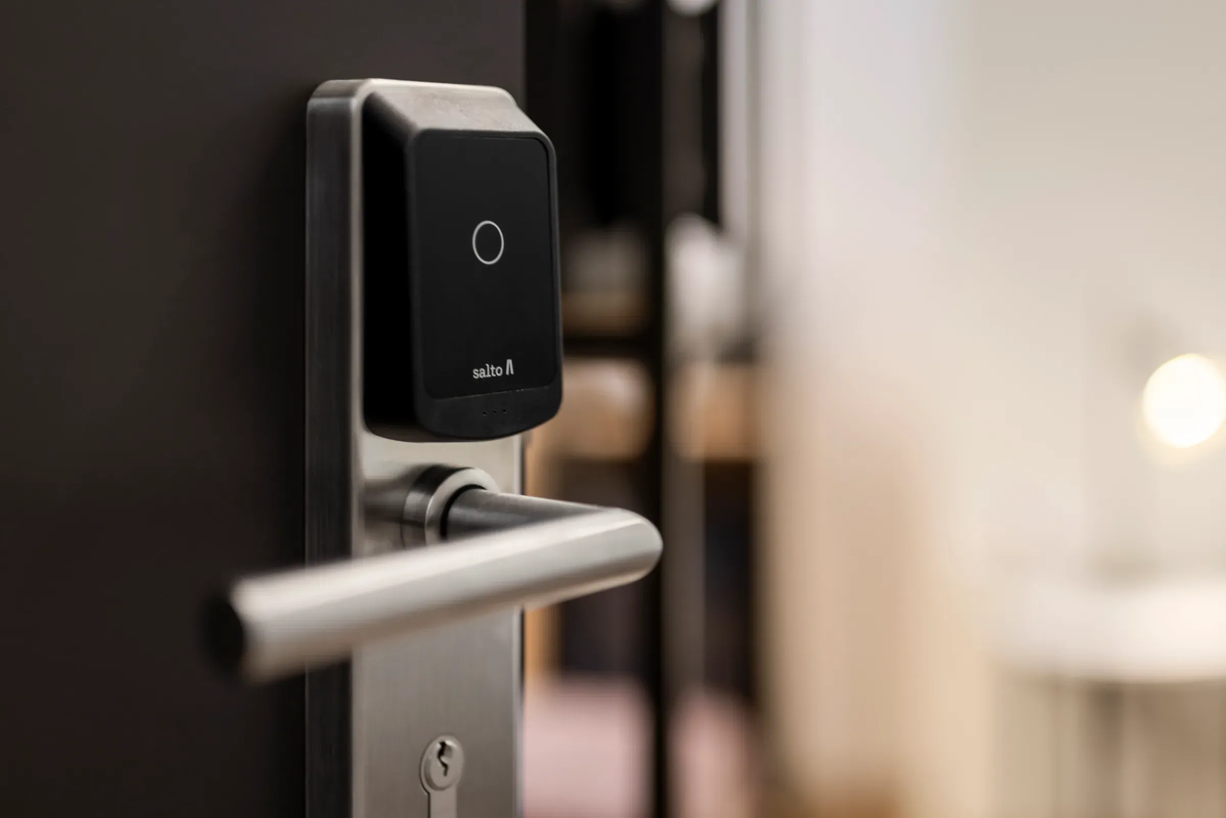 A guest enters an access code on a keyless smart door lock — self check-in