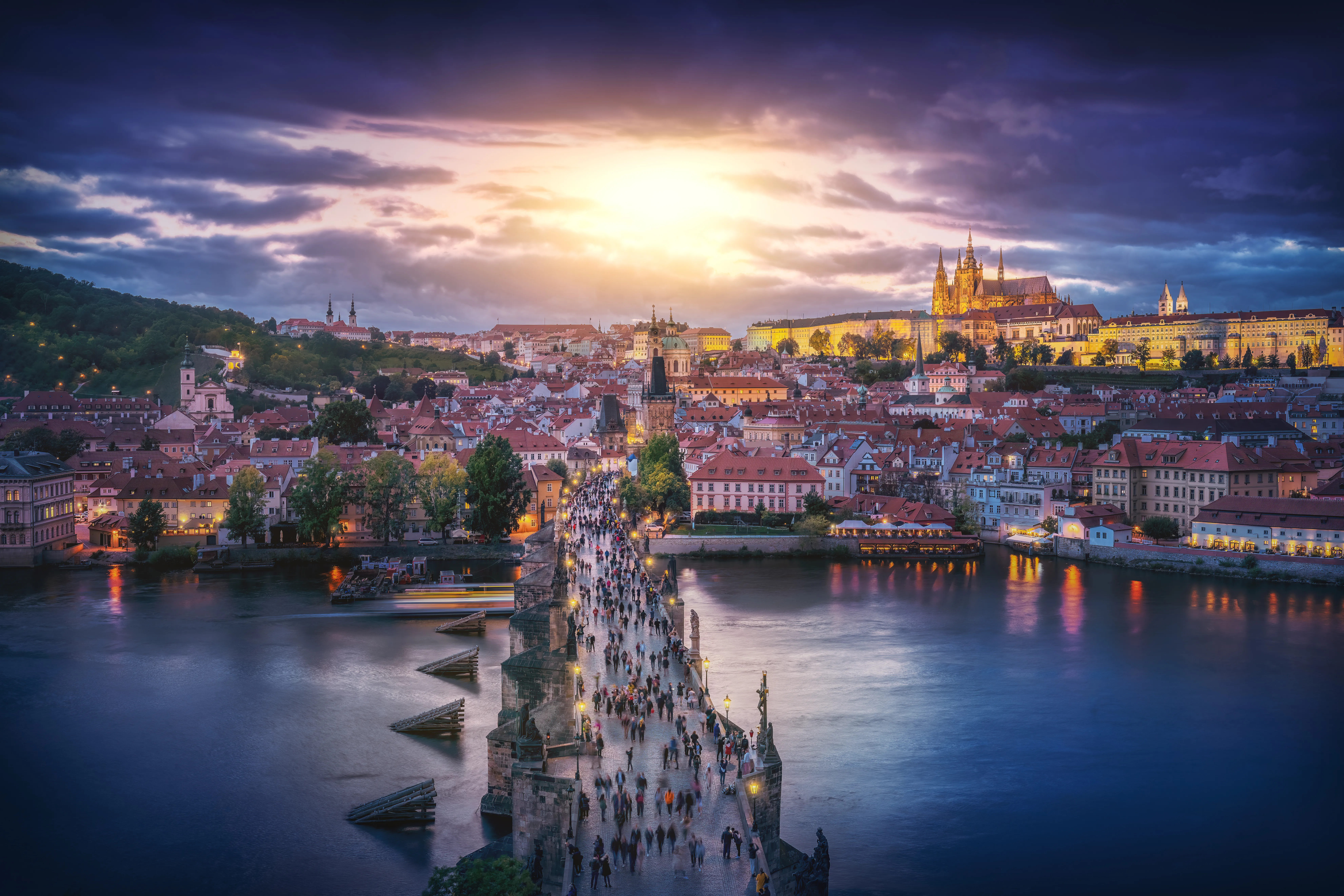 Aerial view of Charles Bridge and the Prague Castle skyline at sunset
